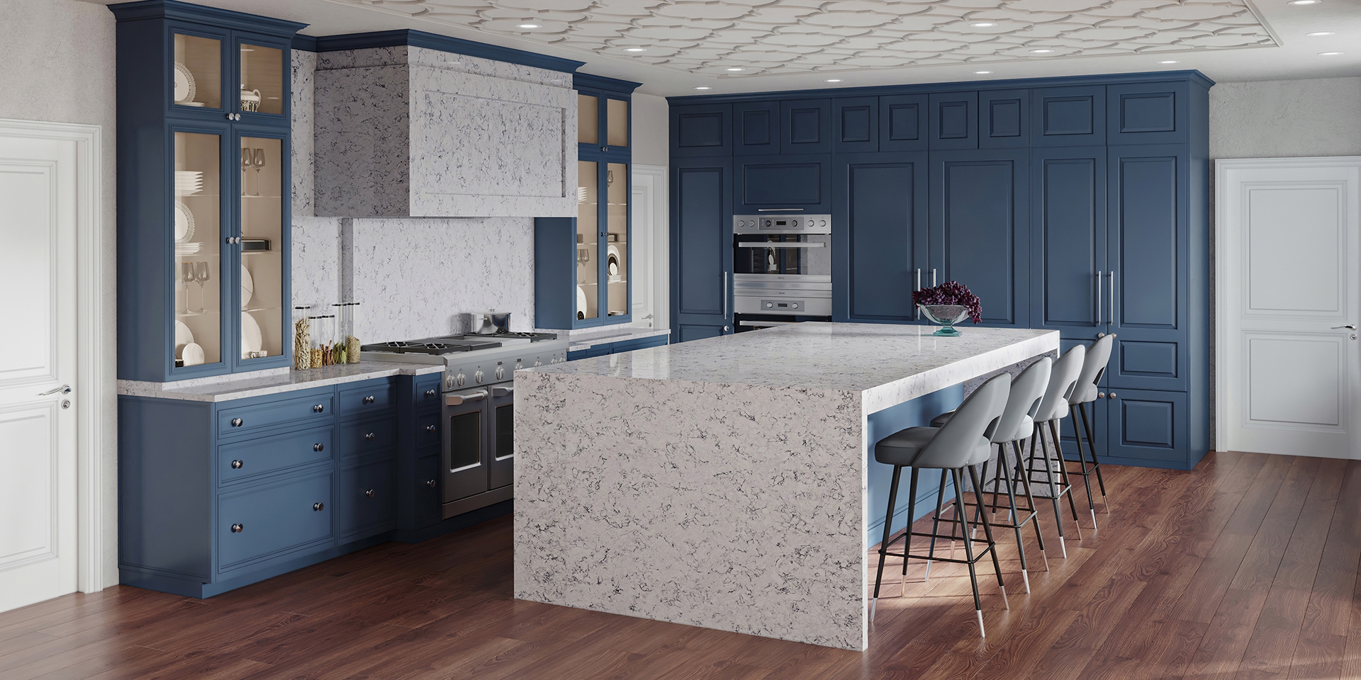 Rich wooden floors pop against blue cabinetry and a striking waterfall edge quartz island in this modern kitchen.