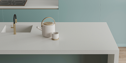 A modern white kitchen island features an integrated sink and waterfall edge - all made from eco-friendly, antimicrobial Quantra quartz.